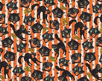May include: A fabric pattern featuring black cats with green eyes and open mouths on a background of vertical orange and white stripes. The design includes small stars and yellow banners with the text HISS, TRICK OR TREAT, and BEWARE OF CAT.