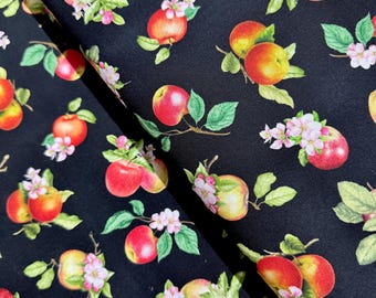 May include: Black fabric with a repeating pattern of red apples, green leaves, and white flowers. The apples are arranged in clusters and are surrounded by green leaves. The flowers are small and white and are scattered throughout the pattern.