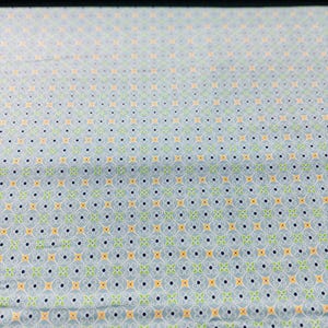 May include: A light blue fabric with a repeating pattern of small yellow, green, and blue shapes. The pattern is a stylized floral design.