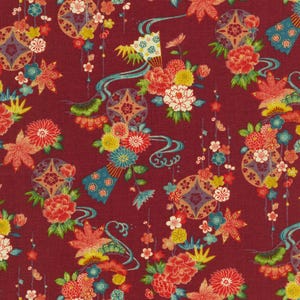 May include: A red fabric with a repeating pattern of colorful flowers, leaves, and geometric shapes. The design is reminiscent of traditional Japanese art.