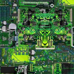 May include: Close-up of a green circuit board with various electronic components, including resistors, capacitors, and integrated circuits. The board is designed with intricate pathways for electrical signals.
