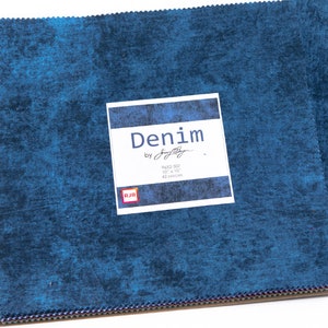 May include: A pack of 42 10-inch by 10-inch fabric squares in a blue denim print. The fabric squares are labeled "Denim by  Jenny Doane" and "9652-507".