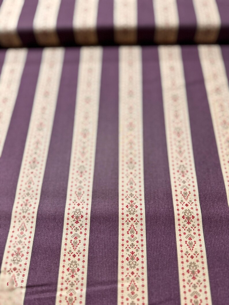 May include: Purple and white striped fabric with a small floral pattern. The fabric has a subtle texture.