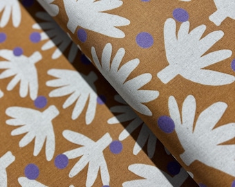 May include: A brown fabric with a white stylized leaf pattern and purple polka dots.