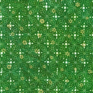 May include: Green fabric featuring a repeating pattern of white starbursts, dots, and small gold floral accents. The design is symmetrical, creating an intricate texture. The fabric has a batik-like appearance.