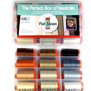 May include: A clear plastic box filled with 12 spools of thread in neutral colors. The box is labeled "The Perfect Box of Neutrals" and features the name "Pat Sloan" and the text "The Voice of Quilting". The box is also labeled "United Notions".
