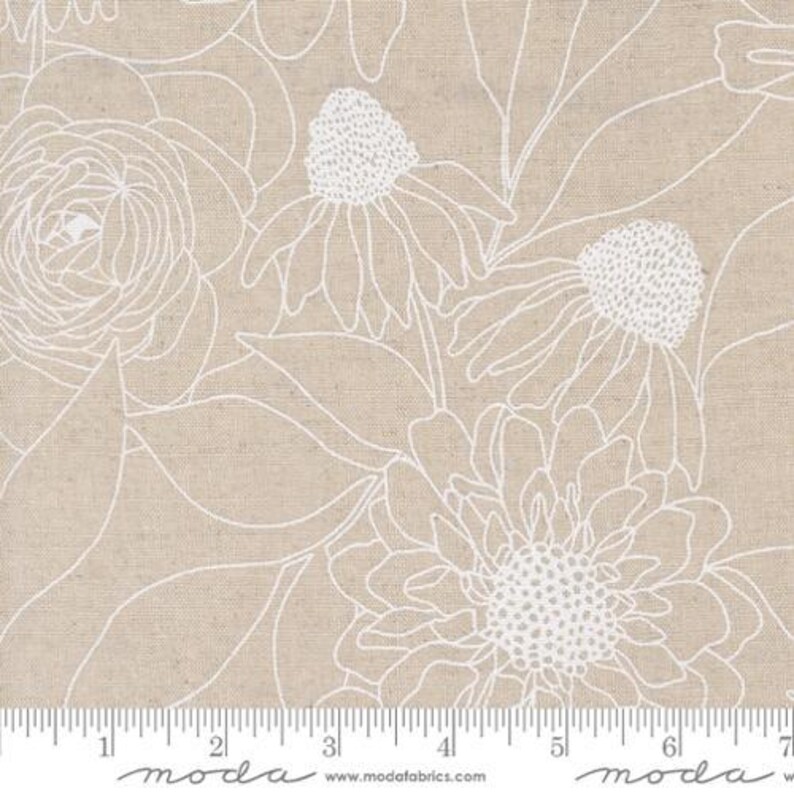 May include: White floral pattern on a beige linen fabric. The pattern features stylized flowers and leaves. The fabric is marked with a ruler in inches.