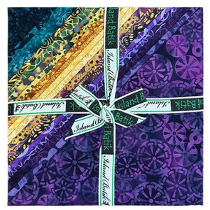 May include: A bundle of 12 fat quarters of purple, blue, and yellow batik fabric with a repeating pattern of circles and swirls. The fabric is labeled "Island Batik".