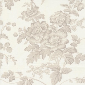May include: Cream-colored fabric with a repeating floral pattern. The design features large, detailed flowers and leaves in a soft, muted beige color. The overall effect is a classic, vintage aesthetic, suitable for various home decor projects.