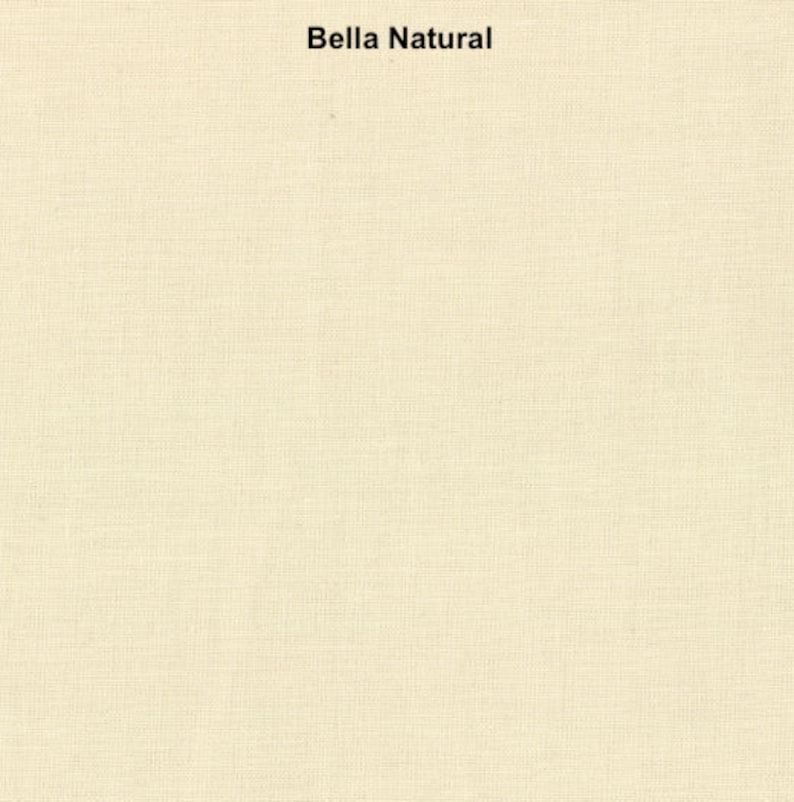 May include: A close-up of a cream-colored fabric with a subtle woven texture. The fabric is smooth and has a slightly matte finish. The text "Bella Natural" is printed in black at the top of the image.