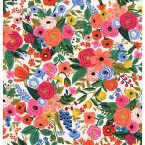 May include: A cream-colored fabric with a floral pattern featuring red, pink, orange, yellow, blue, and green flowers. The fabric is called "Wildwood - Garden Party - Cream" and has the product code "RP100-CR1".