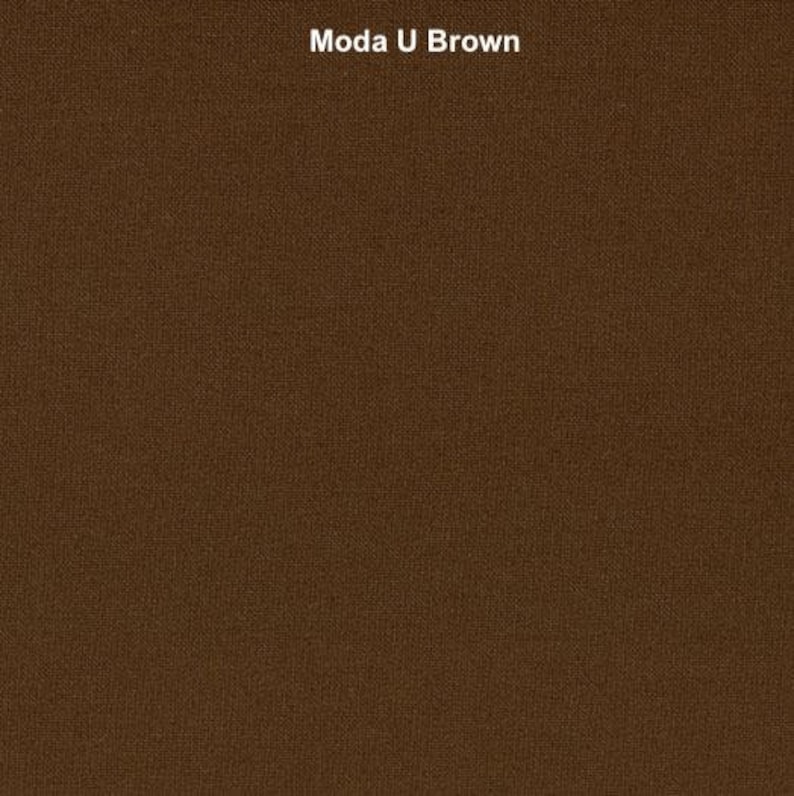 May include: A close-up of a brown fabric with a textured weave. The fabric has a subtle sheen and a slightly rough feel.