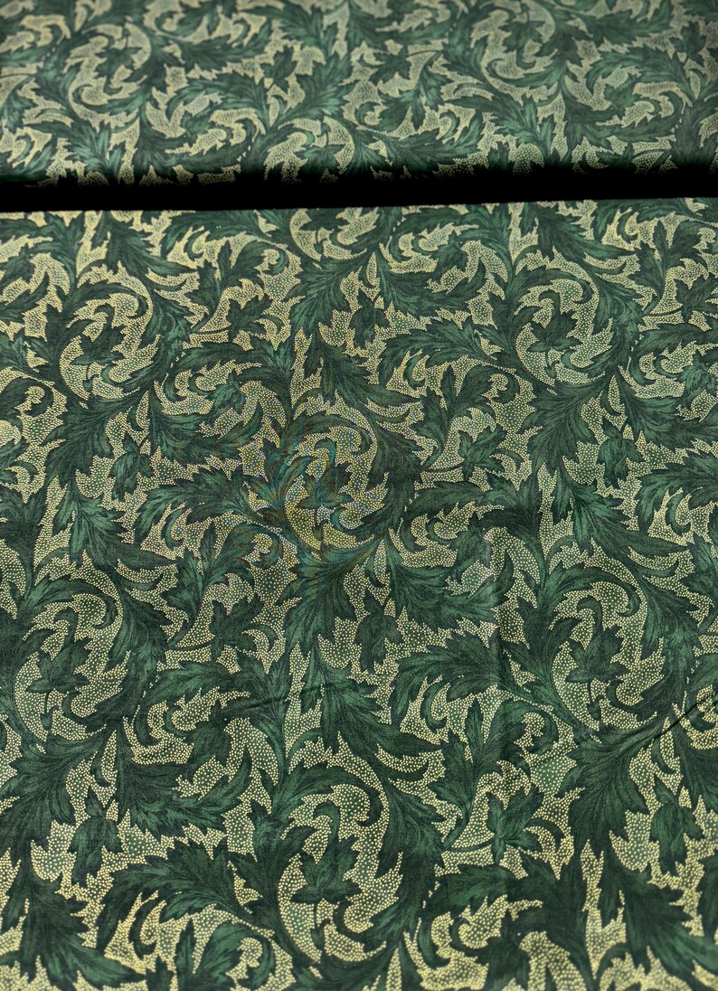 May include: Green fabric with a gold leaf pattern. The fabric has a subtle shimmer.