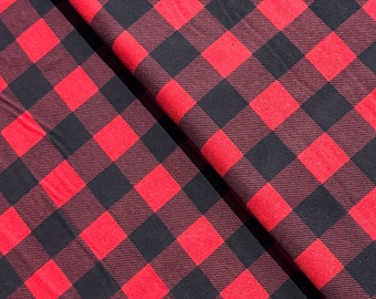May include: Red and black buffalo plaid fabric with a diagonal pattern. The fabric is soft and has a subtle texture.