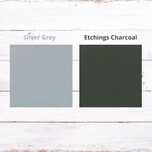 May include: Two fabric swatches, one is a light gray color labeled "Silver Grey" and the other is a dark green color labeled "Etchings Charcoal".