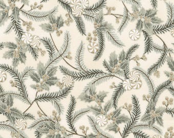 May include: A repeating pattern featuring winter foliage and candies. The design includes sprigs of evergreen needles, holly leaves, and small berries in shades of green and brown. White and tan swirl candies are interspersed throughout the pattern on a cream background.