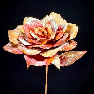 May include: A set of three ceramic mugs with a speckled, matte finish. The mugs are in shades of cream, light gray, and dark gray. Each mug has a simple, minimalist design and a rounded handle.