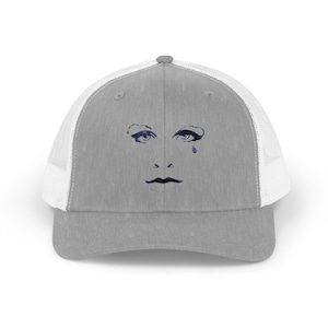 May include: A gray and white trucker hat with a black and white image of a face with a single tear on the front.