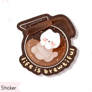 May include: A sticker featuring a cute white cat inside a coffee cup. The cat is light brown and white with rosy cheeks. The cup is brown with the words "life is brewtiful" in a circular design.