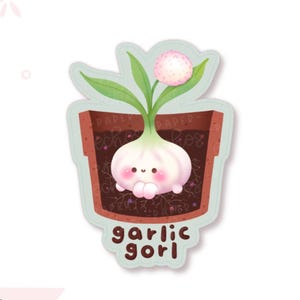 May include: A die-cut sticker featuring a cartoon garlic bulb with a smiling face and pink cheeks planted in a brown terracotta pot. The garlic has green leaves and a small pink flower. The text garlic gorl is printed in brown at the bottom.