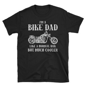May include: Black t-shirt with white text that reads "I'm a Bike Dad Like a Normal Dad, But Much Cooler". A motorcycle is pictured in the centre of the text.