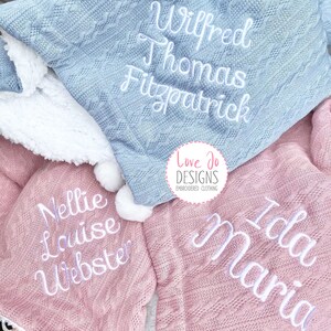 May include: Two personalized knitted blankets, one light blue with the name "Wilfred Thomas Fitzpatrick" and one pink with the names "Nellie Louise Webster" and "Ida Maria".