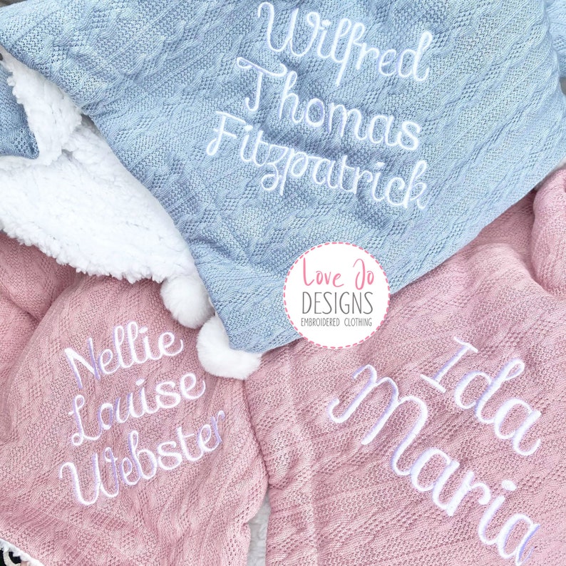 May include: Two personalized knitted blankets, one light blue with the name "Wilfred Thomas Fitzpatrick" and one pink with the names "Nellie Louise Webster" and "Ida Maria".