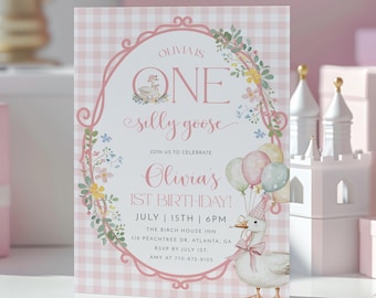May include: A pink and white invitation card for a first birthday party. The card features a cartoon goose holding balloons and a cake. The text reads "Olivia's 1st Birthday!" with the date and time.
