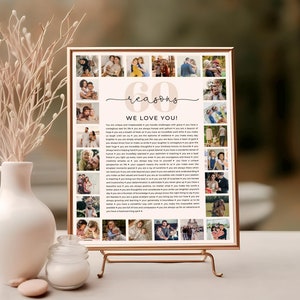 May include: A framed print with a collage of photos and text that reads "60 reasons we love you!" The print is displayed on a gold easel. A white vase with decorative branches is to the left of the print.