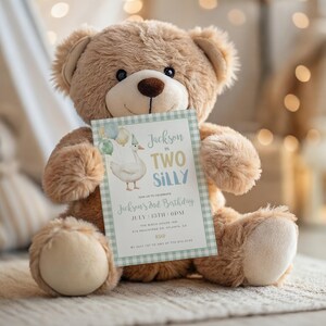 May include: A brown teddy bear holding a birthday invitation. The invitation features a cartoon goose, the text "Jackson in TWO SILLY", and event details. The invitation has a light blue and green gingham border.