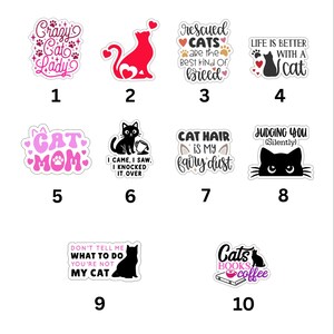 May include: A collection of ten cat-themed stickers featuring various designs and phrases including Crazy Cat Lady, Rescued Cats are the Best Kind of Breed, Life is Better with a Cat, Cat Mom, I Came I Saw I Knocked It Over, Cat Hair is My Fairy Dust, Judging You Silently, Don't Tell Me What To Do You're Not My Cat, and Cats Books Coffee.