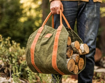 May include: A green canvas bag with brown leather straps and handles, filled with logs of firewood.