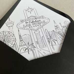 May include: Black and white illustration of the Las Vegas skyline with the iconic "Meet Us in Fabulous Las Vegas, Nevada" sign. The illustration includes the Eiffel Tower, the High Roller observation wheel, palm trees, and other buildings.