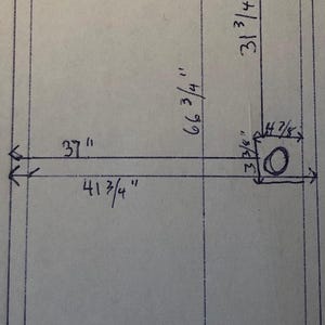 May include: A hand-drawn technical diagram on paper featuring a rectangular frame with dimensions labeled in inches. The drawing includes a 1 inch top frame, 1/2 inch bottom frame, a 37 inch width, 66 3/4 inch height, and a 4 7/8 by 3 3/8 inch inset box.