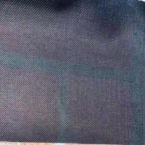 May include: Close-up of a dark blue, textured fabric with a subtle, iridescent sheen. The material has a tight, woven pattern, creating a grid-like appearance. The fabric's surface reflects hints of green and purple.