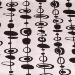 May include: Black and white abstract pattern with repeating circles and ovals, resembling a chain of beads. The pattern is on a white background.