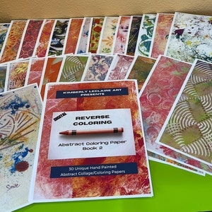 May include: A stack of 30 unique hand-painted abstract collage colouring papers. The papers are in various colours and patterns. The papers are titled "Reverse Colouring: Abstract Colouring Paper Book 2".