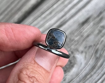 Offset oxidized silver Leland blue ring.