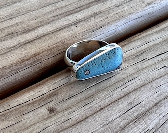 Freeform Leland blue D-shaped ring with half round band.