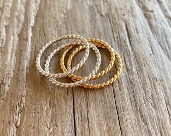 Twisted band stack rings in gold and silver