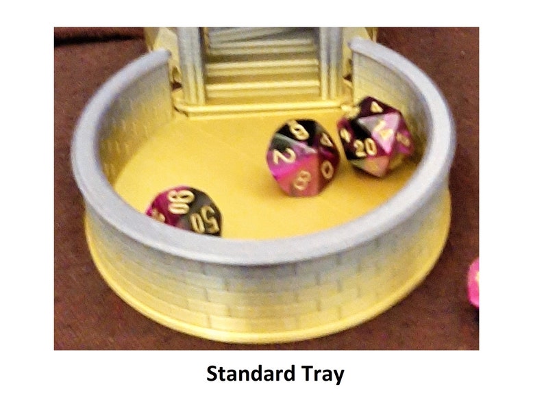 May include: A gray and yellow plastic tray with a stone-like texture. The tray has three purple and gold dice inside.