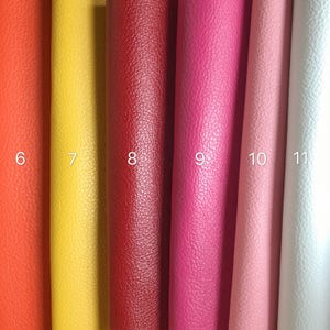 May include: Six samples of leather fabric in different colors: orange, yellow, red, pink, light pink, and white. The samples are numbered 6 through 11.