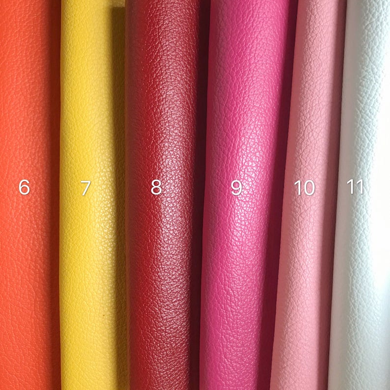 May include: Six samples of leather fabric in different colors: orange, yellow, red, pink, light pink, and white. The samples are numbered 6 through 11.