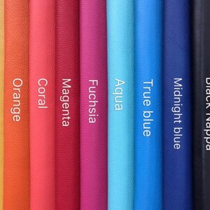 May include: A selection of leather swatches in various colors, including yellow, orange, coral, magenta, fuchsia, aqua, true blue, midnight blue, and black. The swatches are arranged vertically, with the black swatch on the right.