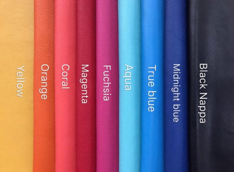 May include: A selection of leather swatches in various colors, including yellow, orange, coral, magenta, fuchsia, aqua, true blue, midnight blue, and black. The swatches are arranged vertically, with the black swatch on the right.
