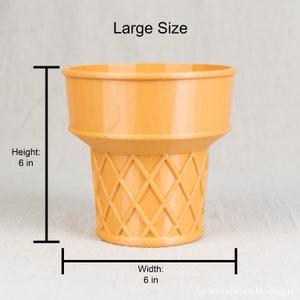 A single large sized ice cream cone planter on a plain, off white studio background. There are brackets marking the dimensions. Height: 6 inches. Width: 6 inches. The ice cream cone has a semi smooth, slightly glossy finish.