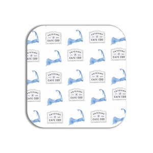 May include: A white square coaster with a repeating pattern of blue watercolor Cape Cod outlines and the text "Entering Cape Cod" in a white rectangle.