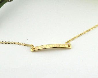 May include: A gold necklace with a thin chain and a small, flat bar pendant with the inscription "Together Forever".
