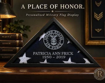 May include: A triangular black wooden display case containing a folded United States flag. The glass front features the United States Air Force emblem, the name PATRICIA ANN FRICK, and the years 1950 – 2019 etched in white lettering.