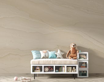 May include: A neutral-toned nursery scene featuring a bench with pillows, a plush sloth, and a star-shaped pillow. A white storage unit holds toys and books. A toy airplane and a pink ball are on the floor, with a textured wall in the background.